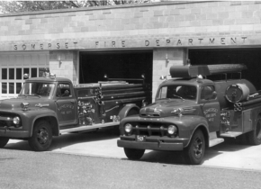 Black and white image of the old Somerset Fire Department with two fire trucks parked out front.