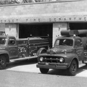 Black and white image of the old Somerset Fire Department with two fire trucks parked out front.